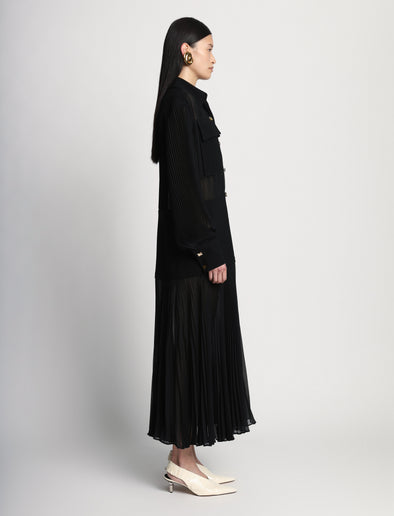 Side full length image of model wearing Sheer Pleated Flou Dress in BLACK