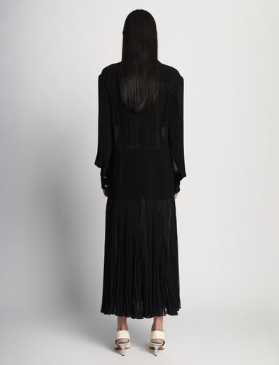 Back full length image of model wearing Sheer Pleated Flou Dress in BLACK