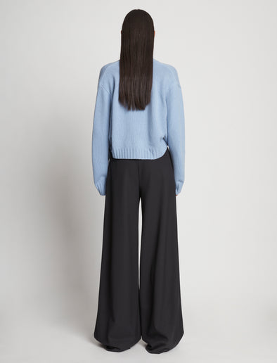 Back full length image of model wearing Eco Cashmere Cardigan in LIGHT BLUE