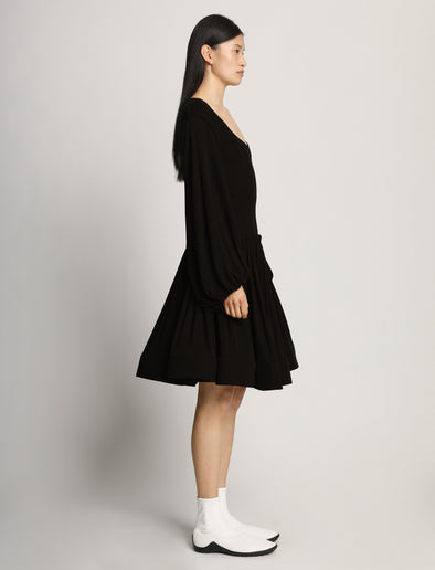 Side full length image of model wearing Viscose Crepe Jersey Dress in BLACK