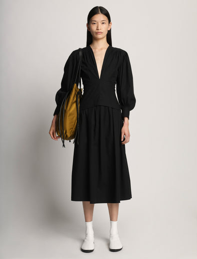 Front image of model carrying Nylon Drawstring Tote in FATIGUE