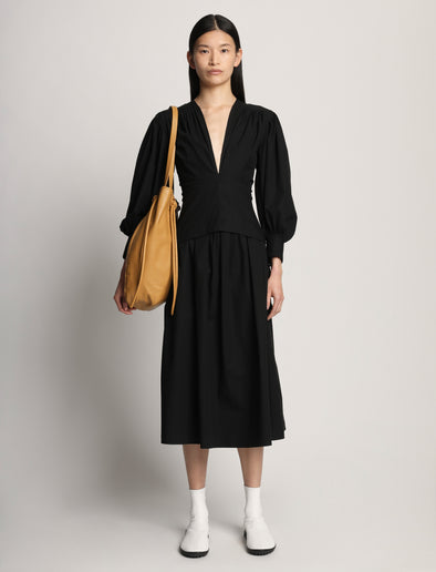 Image of model carrying Drawstring Tote in CARAMEL