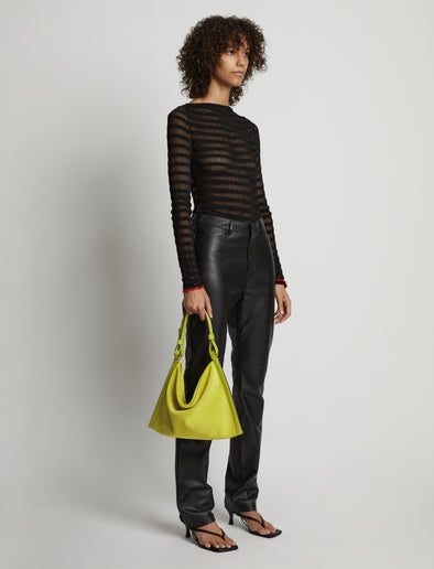 Image of model wearing Minetta Suede Bag in MATCHA