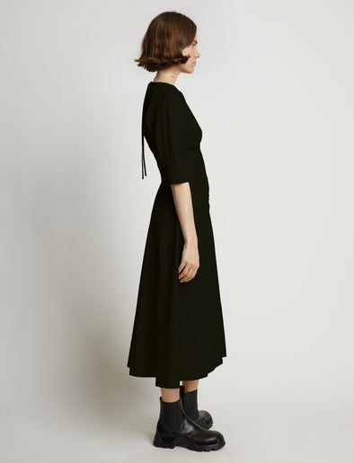 Side image of model wearing Poplin V-Neck Puff Sleeve Dress in black