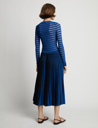 Back image of model wearing Sheer Stripe Sweater in cerulean/black