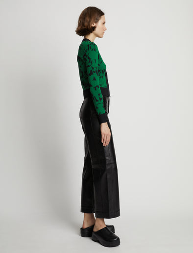 Side image of model wearing Knit Floral Cardigan in green/black