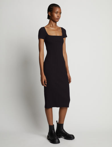 Side image of model wearing Rib Knit Short Sleeve Dress in black