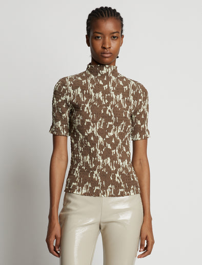 Cropped front image of model wearing Viscose Flou Smocked Top in buttercream/fawn