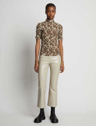 Front image of model wearing Viscose Flou Smocked Top in buttercream/fawn