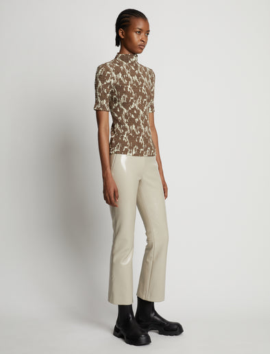 Side image of model wearing Viscose Flou Smocked Top in buttercream/fawn
