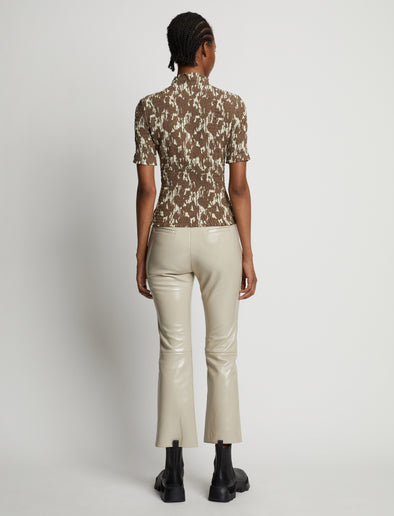 Back image of model wearing Viscose Flou Smocked Top in buttercream/fawn