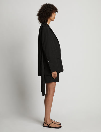 Side image of model wearing Cotton Linen Shorts in black