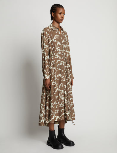 Side image of model wearing Printed Long Sleeve Shirt Dress in buttercream/coffee
