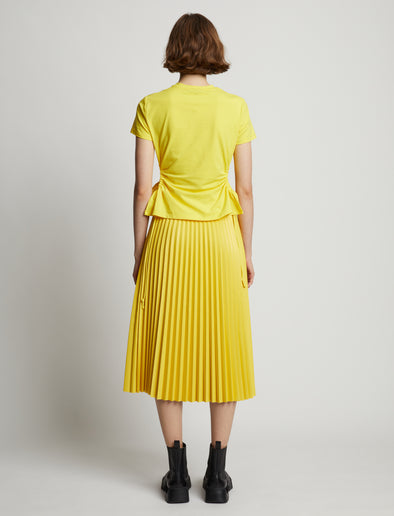 Back image of model wearing Faux Leather Pleated Midi Skirt in sun