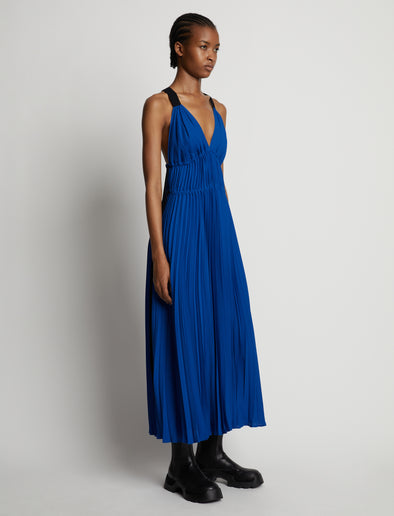 Side image of model wearing Broomstick Pleated Tank Dress in cerulean
