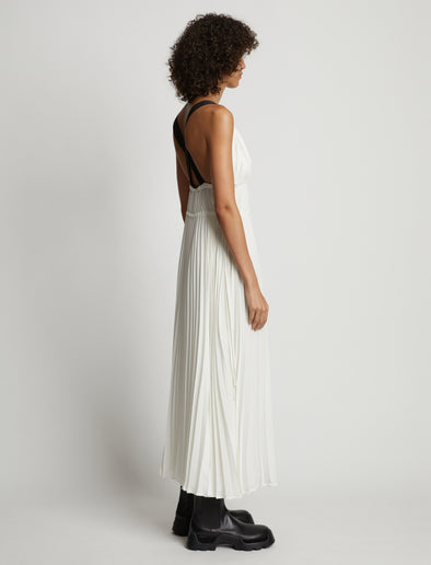 Side image of model wearing Broomstick Pleated Tank Dress in off white