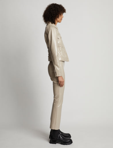 Side image of model wearing Vinyl Cropped Jacket in fawn