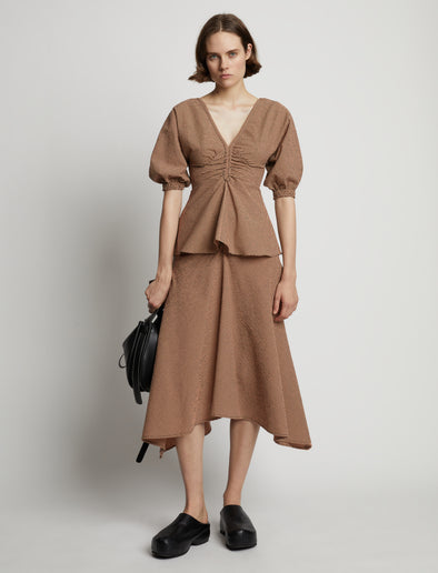 Front image of model wearing Gingham Long Sleeve Peplum Top in coral/black
