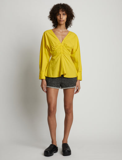 Front image of model wearing Poplin V-Neck Top in sun