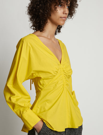 Detail image of model wearing Poplin V-Neck Top in sun