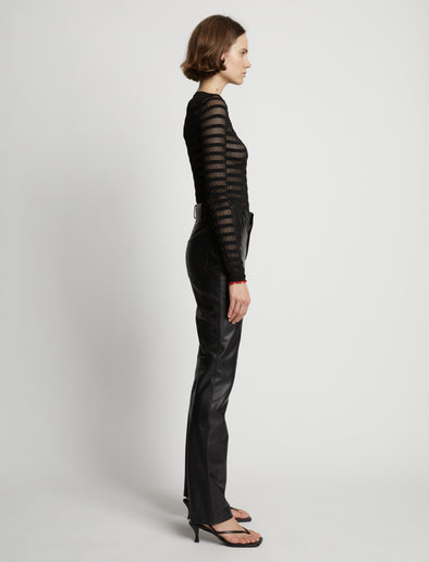 Side image of model wearing Sheer Stripe Sweater in black/red