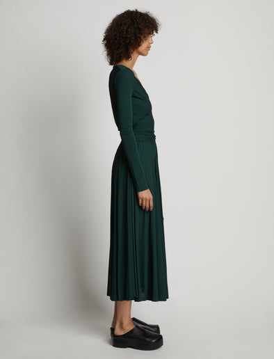 Side image of model wearing Matte Crepe Wrap Dress in pine
