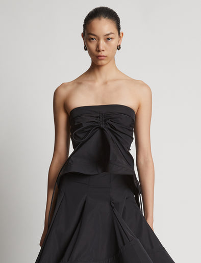 Cropped front image of model wearing Technical Nylon Strapless Top in black