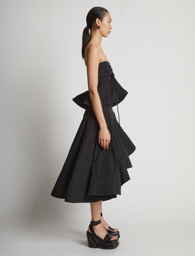 Side image of model wearing Technical Nylon Strapless Top in black