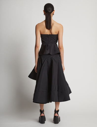 Back image of model wearing Technical Nylon Strapless Top in black