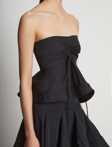 Detail image of model wearing Technical Nylon Strapless Top in black