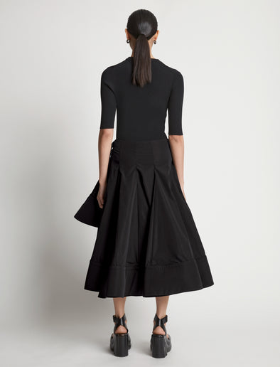 Back image of model wearing Technical Nylon Wrap Skirt in black