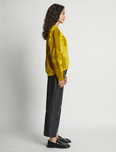 Side image of model wearing Tie Dye Sweatshirt in sulphur/muted lime