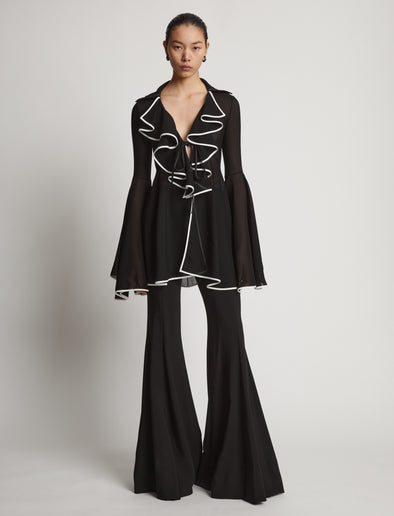 Front image of model wearing Solid Mesh Ruffle Shirt in black