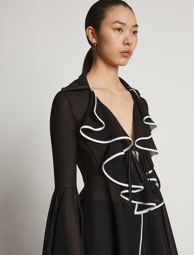 Detail image of model wearing Solid Mesh Ruffle Shirt in black