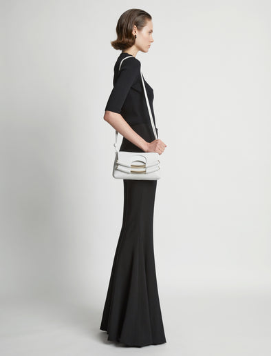 Image of model carrying Small Bar Bag in OPTIC WHITE