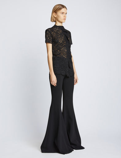 Side image of model wearing Stretch Lace Top in black