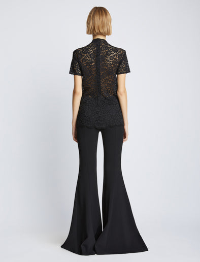Back image of model wearing Stretch Lace Top in black