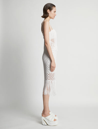 Side image of model wearing Lacquered Knit Dress in white