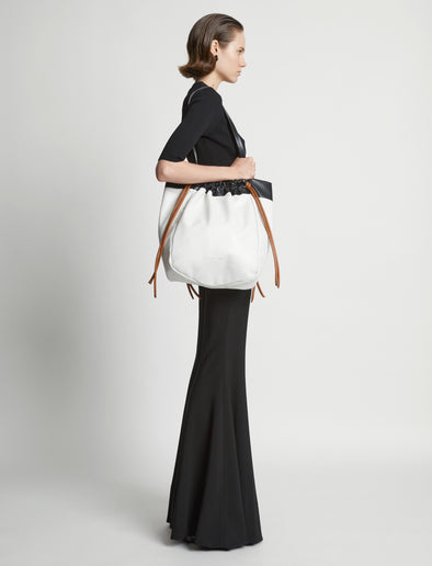 Image of model wearing Color Block Drawstring Tote in OPTIC WHITE/BLACK