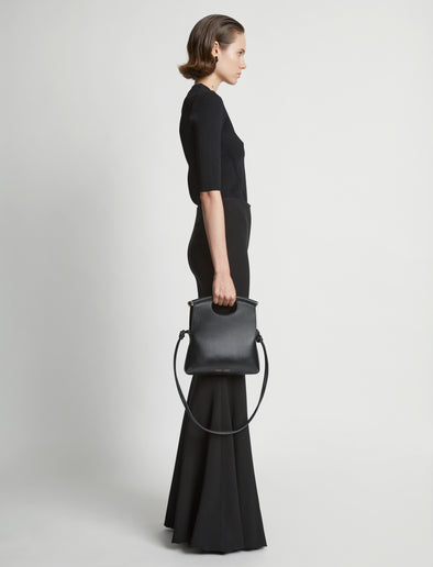 Image of model carrying Small Bar Bag in BLACK