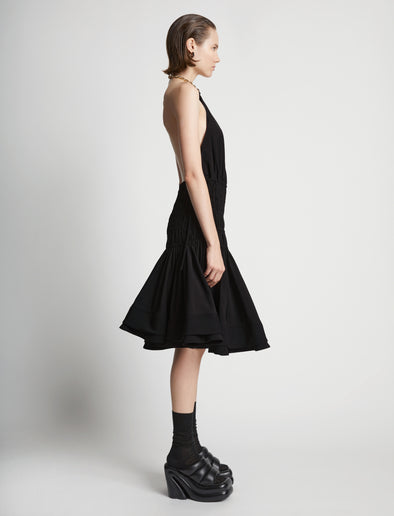 Side image of model wearing Stretch Nylon Dress in black