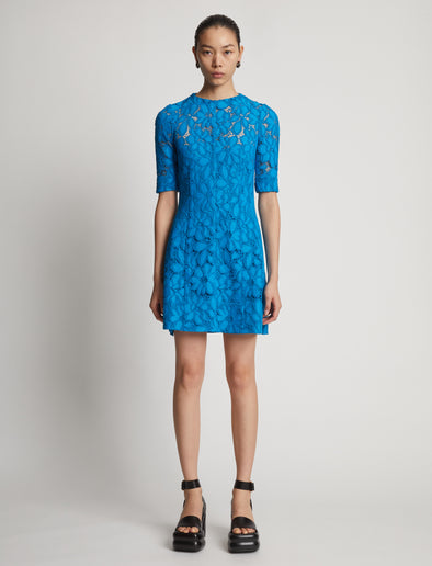 Front image of model wearing Lace Dress in turquoise