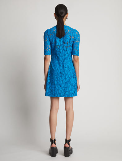 Back image of model wearing Lace Dress in turquoise