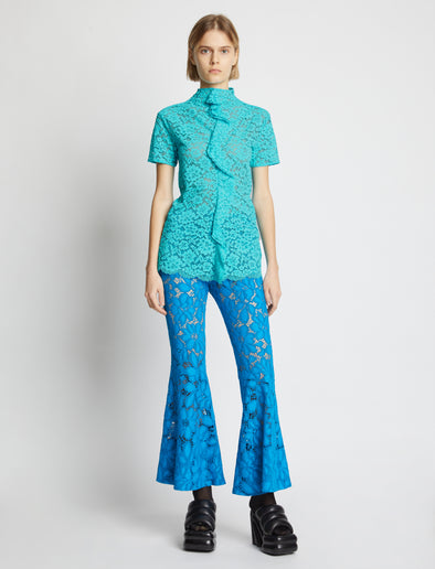 Front image of model wearing Stretch Lace Top in cyan