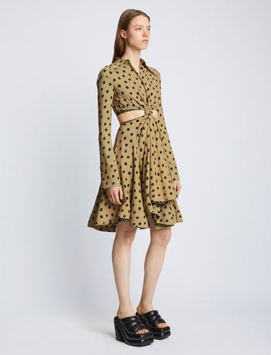 Side image of model wearing Printed Dot Cut Out Shirt Dress in khaki black