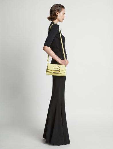 Image of model carrying Small Bar Bag in LEMONGRASS