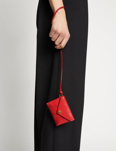 Image of model carrying Card holder in scarlet