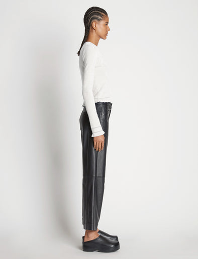 Side image of model wearing Cropped Turtleneck Chenille Sweater in off white