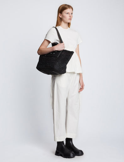 Image of model carrying Large Morris Raffia Tote in BLACK on shoulder