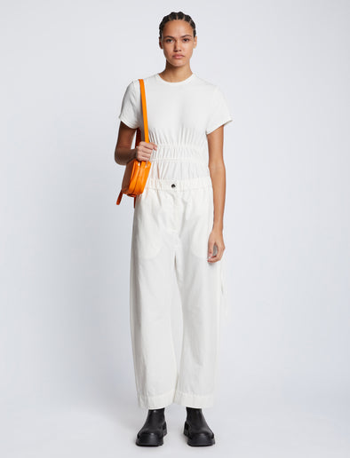 Front image of model carrying Watts Leather Camera Bag in TANGERINE
